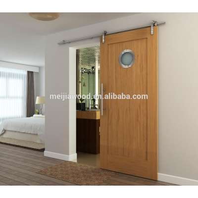 Glass barn door with port hole designs glass doors